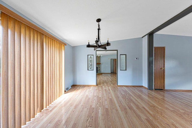 108 Hilton Ct, Mankato, MN 56001 - unfurnished dining area featuring a chandelier and light wood-style flooring
