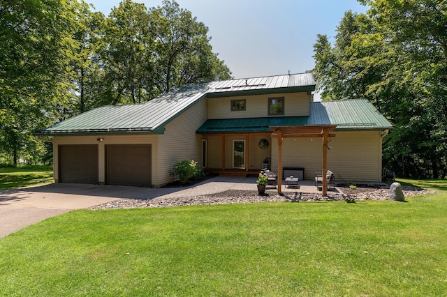 20428 Pheasant Trl, Brainerd, MN 56401 - view of front of house featuring covered porch, an attached garage, a front lawn, driveway, and a metal roof