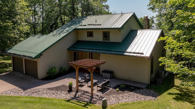 20428 Pheasant Trl, Brainerd, MN 56401 - view of front of property with a standing seam roof, a metal roof, a chimney, a front lawn, and a patio area