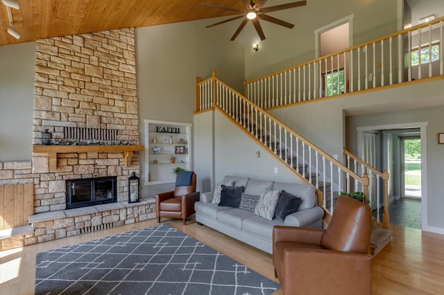20428 Pheasant Trl, Brainerd, MN 56401 - living area with wooden ceiling, high vaulted ceiling, stairway, a ceiling fan, and a stone fireplace