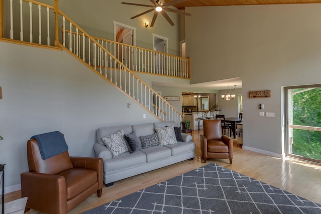 20428 Pheasant Trl, Brainerd, MN 56401 - living room with high vaulted ceiling, stairway, ceiling fan, wood finished floors, and a chandelier