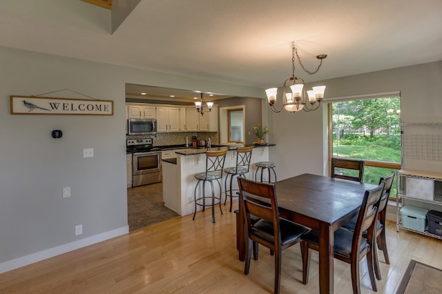 20428 Pheasant Trl, Brainerd, MN 56401 - dining area with a chandelier, light wood-style flooring, and recessed lighting