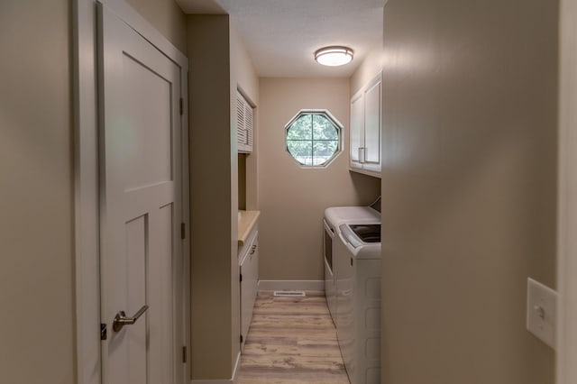 20428 Pheasant Trl, Brainerd, MN 56401 - washroom with cabinet space, washing machine and dryer, light wood finished floors, and a textured ceiling