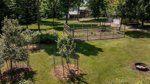 20428 Pheasant Trl, Brainerd, MN 56401 - view of yard featuring a garden, a garage, and an outdoor structure