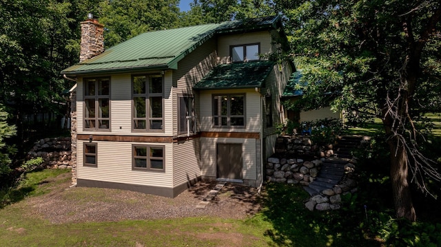 20428 Pheasant Trl, Brainerd, MN 56401 - rear view of house with a chimney and a metal roof