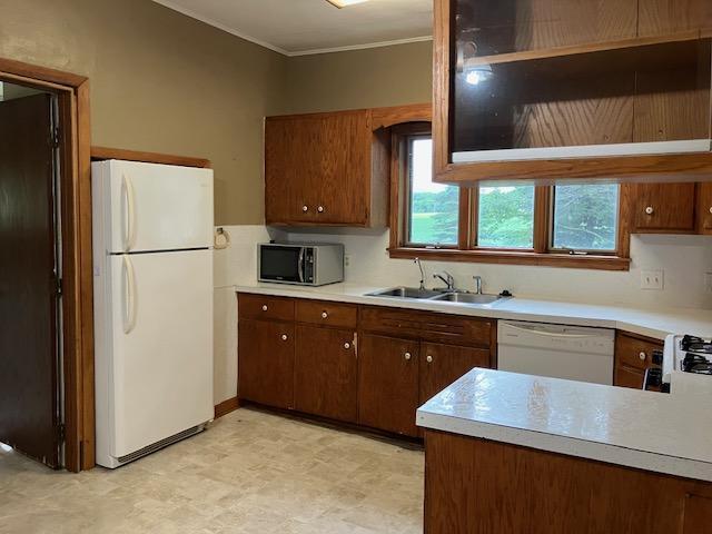 358 Cypress Ave, New Richland, MN 56072 - kitchen featuring white appliances, ornamental molding, light countertops, and plenty of natural light