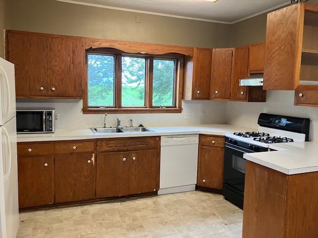 358 Cypress Ave, New Richland, MN 56072 - kitchen with white appliances, crown molding, light countertops, and brown cabinets