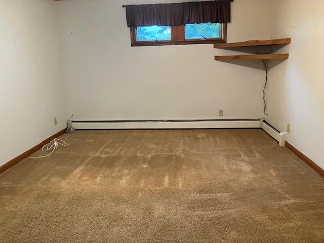 358 Cypress Ave, New Richland, MN 56072 - carpeted spare room featuring a baseboard radiator and baseboards