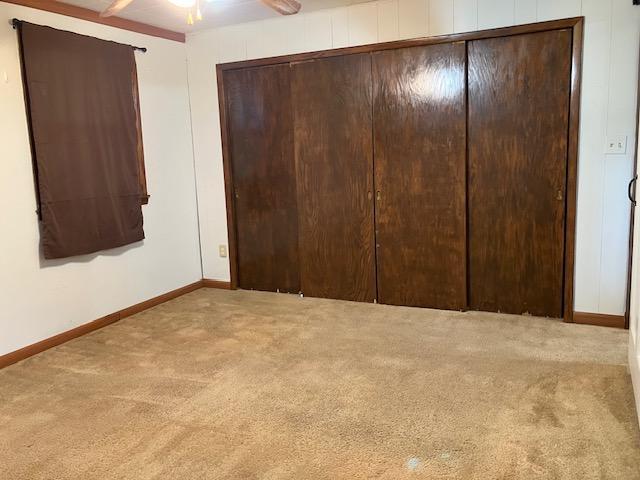 358 Cypress Ave, New Richland, MN 56072 - unfurnished bedroom with carpet and a closet