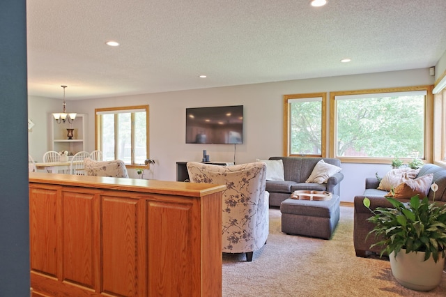 13334 Silverod Ct NW, Andover, MN 55304 - living area featuring light colored carpet, a textured ceiling, recessed lighting, and a chandelier