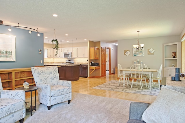 13334 Silverod Ct NW, Andover, MN 55304 - living area with a chandelier, light wood-type flooring, track lighting, and recessed lighting
