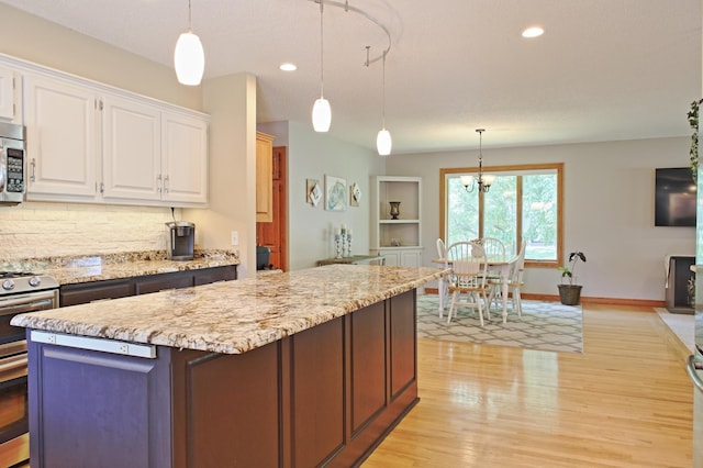 13334 Silverod Ct NW, Andover, MN 55304 - kitchen with stainless steel appliances, white cabinetry, light wood-style floors, a kitchen island, and recessed lighting