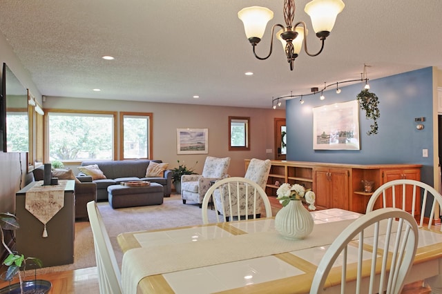 13334 Silverod Ct NW, Andover, MN 55304 - dining area with recessed lighting, a chandelier, and a textured ceiling