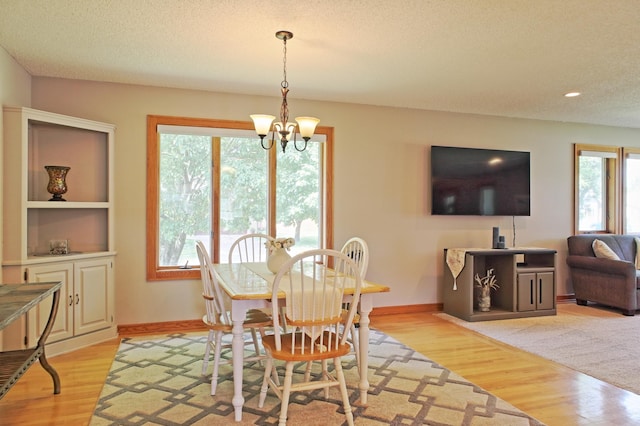 13334 Silverod Ct NW, Andover, MN 55304 - dining room featuring plenty of natural light, a chandelier, light wood-style floors, a textured ceiling, and recessed lighting