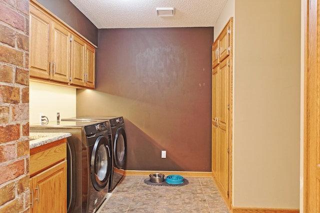 13334 Silverod Ct NW, Andover, MN 55304 - washroom featuring cabinet space, washing machine and dryer, and a textured ceiling