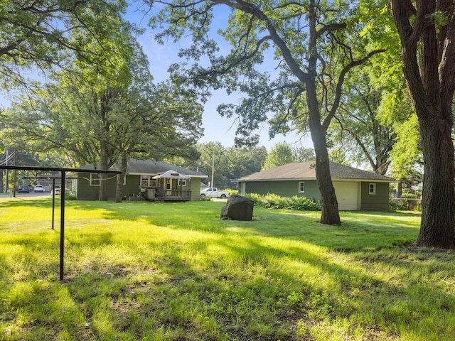 11827 Douglas Dr N, Champlin, MN 55316 - view of green lawn featuring a wooden deck and a garage