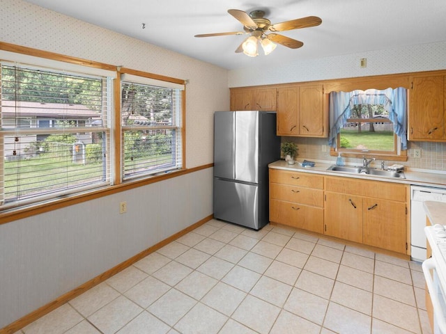 11827 Douglas Dr N, Champlin, MN 55316 - kitchen with freestanding refrigerator, wallpapered walls, dishwasher, light countertops, and a ceiling fan