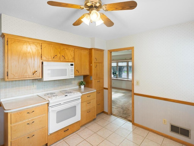 11827 Douglas Dr N, Champlin, MN 55316 - kitchen featuring white appliances, light countertops, wallpapered walls, ceiling fan, and light tile patterned floors