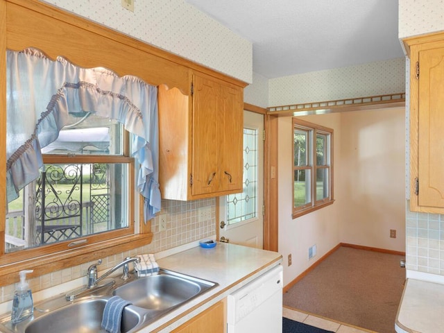 11827 Douglas Dr N, Champlin, MN 55316 - kitchen with white dishwasher, light countertops, wallpapered walls, carpet floors, and backsplash