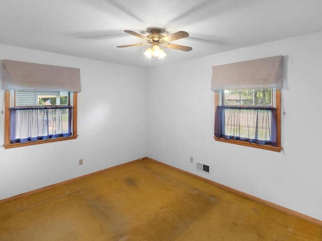 11827 Douglas Dr N, Champlin, MN 55316 - carpeted empty room featuring a ceiling fan and baseboards