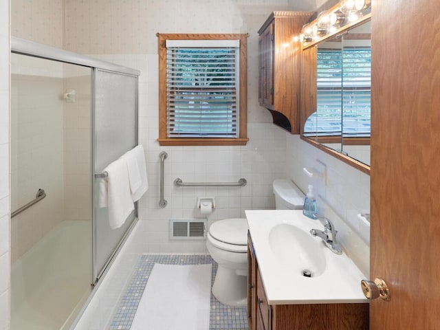 11827 Douglas Dr N, Champlin, MN 55316 - bathroom with vanity, combined bath / shower with glass door, tile walls, wallpapered walls, and tile patterned floors