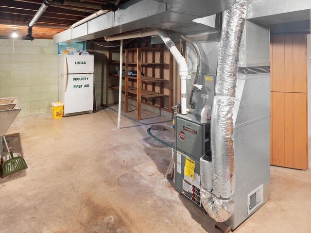 11827 Douglas Dr N, Champlin, MN 55316 - unfinished below grade area with freestanding refrigerator, heating unit, and concrete block wall