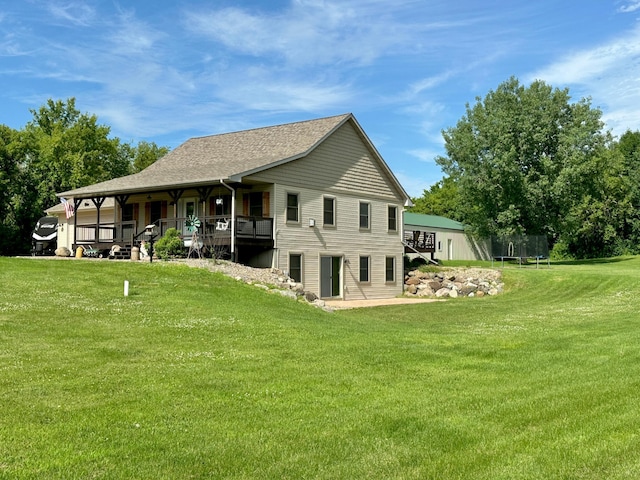 2161 170th St, New Richmond, WI 54017 - rear view of house featuring a trampoline and a lawn