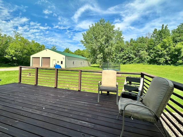 2161 170th St, New Richmond, WI 54017 - wooden terrace featuring a trampoline, a detached garage, an outdoor structure, and a yard