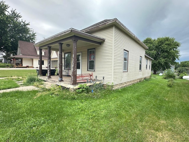 203 4th St, Beaver Creek, MN 56116 - view of front facade featuring covered porch and a front lawn