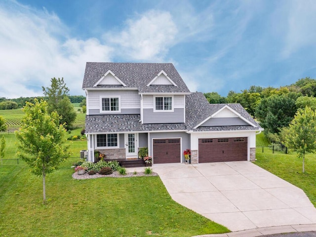 910 Burton Cir, Montrose, MN 55363 - view of front facade featuring an attached garage, concrete driveway, roof with shingles, and stone siding