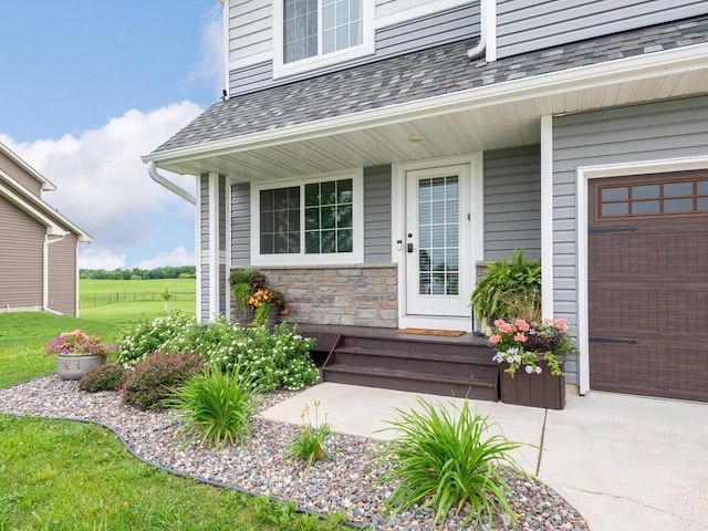 910 Burton Cir, Montrose, MN 55363 - doorway to property featuring a garage, a shingled roof, and stone siding