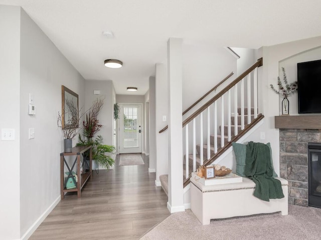 910 Burton Cir, Montrose, MN 55363 - entrance foyer with stairway, a fireplace, and wood finished floors