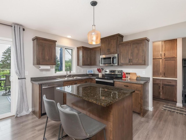 910 Burton Cir, Montrose, MN 55363 - kitchen with appliances with stainless steel finishes, light wood-style flooring, a center island, pendant lighting, and recessed lighting