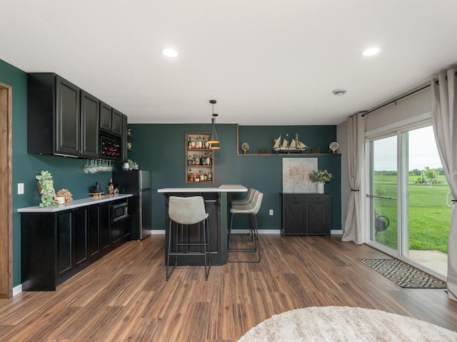 910 Burton Cir, Montrose, MN 55363 - indoor dry bar featuring freestanding refrigerator, wood finished floors, recessed lighting, and hanging light fixtures