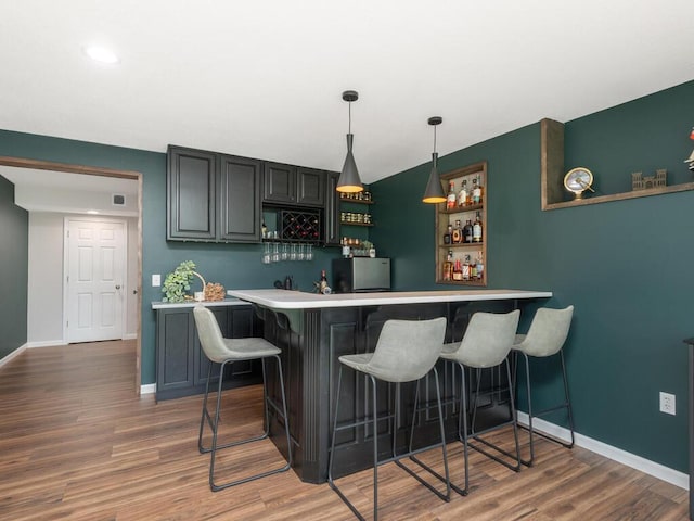 910 Burton Cir, Montrose, MN 55363 - indoor wet bar featuring freestanding refrigerator, wood finished floors, hanging light fixtures, and recessed lighting