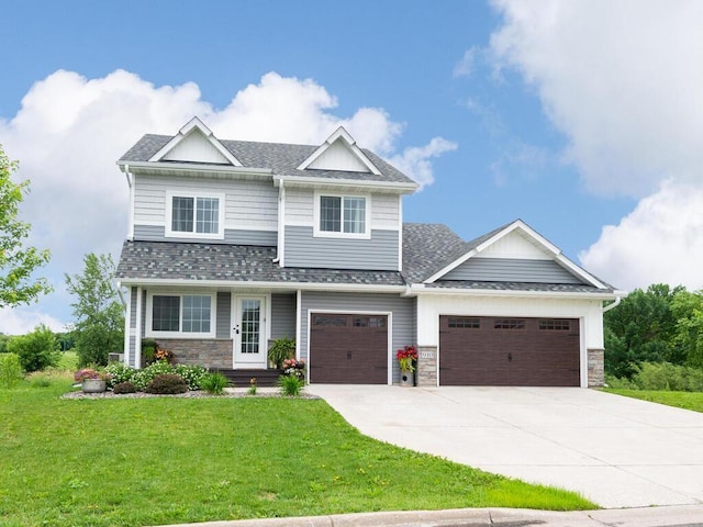 910 Burton Cir, Montrose, MN 55363 - craftsman-style house featuring driveway, a front yard, a garage, roof with shingles, and stone siding