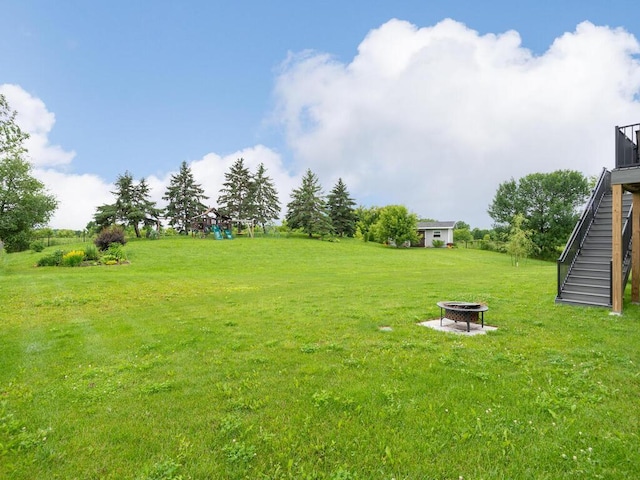 910 Burton Cir, Montrose, MN 55363 - view of green lawn with an outdoor fire pit and stairs
