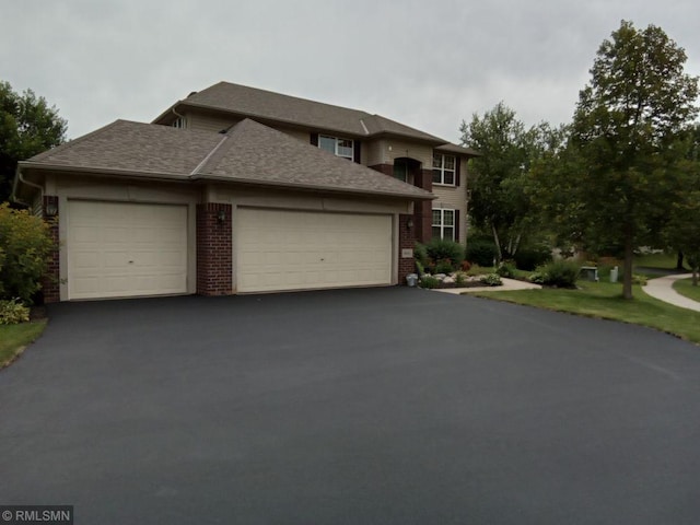 6640 Fountain Ct N, Maple Grove, MN 55311 - view of front of home featuring an attached garage, asphalt driveway, a shingled roof, and brick siding