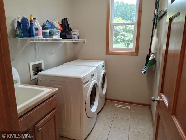 6640 Fountain Ct N, Maple Grove, MN 55311 - laundry area with washer and clothes dryer, cabinet space, and light tile patterned floors