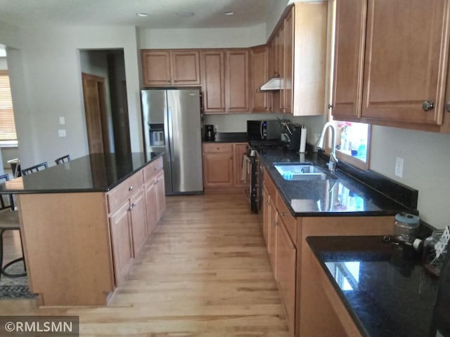 6640 Fountain Ct N, Maple Grove, MN 55311 - kitchen featuring light wood finished floors, stainless steel fridge, a center island, gas range oven, and a breakfast bar area