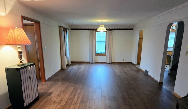 808 5th St SW, Pipestone, MN 56164 - empty room with arched walkways and dark wood-type flooring