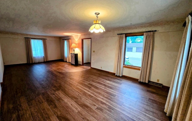 808 5th St SW, Pipestone, MN 56164 - spare room with dark wood-style flooring and baseboards