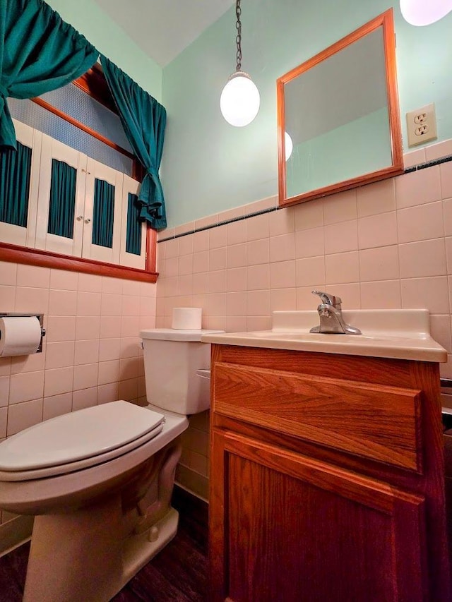 808 5th St SW, Pipestone, MN 56164 - bathroom featuring tile walls, vanity, and wood finished floors