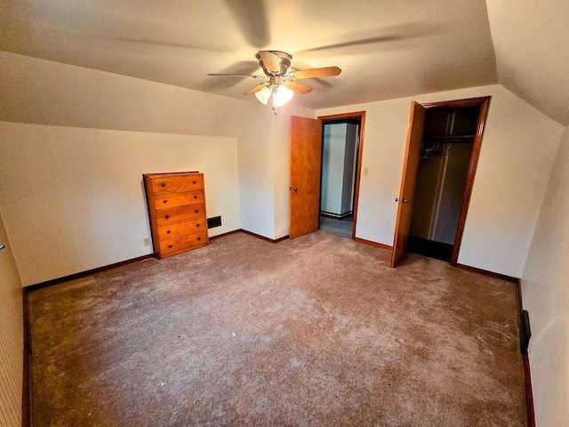 808 5th St SW, Pipestone, MN 56164 - unfurnished bedroom featuring carpet, vaulted ceiling, a closet, and a ceiling fan