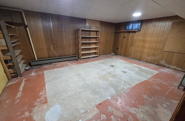 808 5th St SW, Pipestone, MN 56164 - finished below grade area featuring a baseboard radiator, wood walls, and stairs