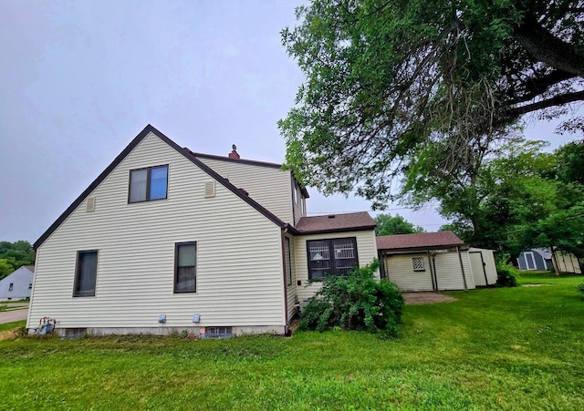 808 5th St SW, Pipestone, MN 56164 - rear view of property with a lawn and a chimney