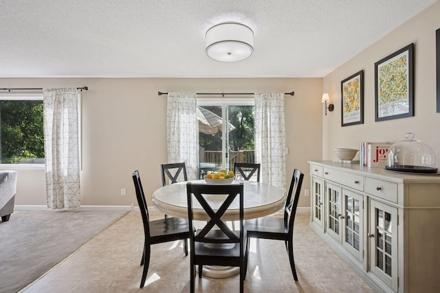 6520 Nathan Ln N, Maple Grove, MN 55369 - dining space featuring a textured ceiling and baseboards