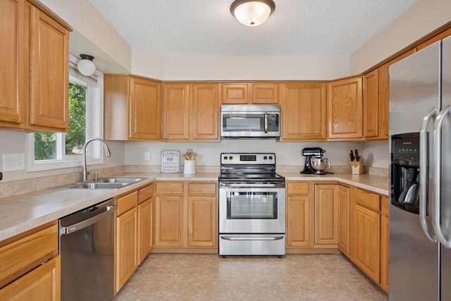 6520 Nathan Ln N, Maple Grove, MN 55369 - kitchen featuring stainless steel appliances, a textured ceiling, and light countertops
