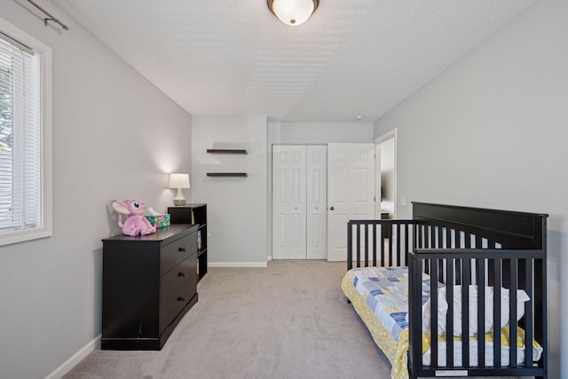 6520 Nathan Ln N, Maple Grove, MN 55369 - bedroom with light colored carpet, a closet, and a textured ceiling