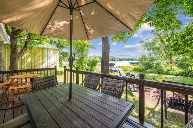 51122 Long Point Pl, Mcgregor, MN 55760 - wooden terrace featuring outdoor dining space and a water view